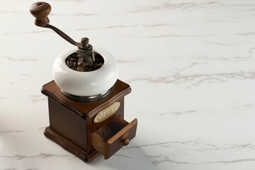 Classic coffee grinder with an open powder reservoir - obrazy, fototapety, plakaty