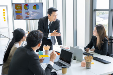 A group of young Asian businessmen Talking and planning work happily and have fun. at the company's office