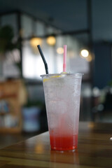 A refreshing soda is placed in a transparent cup.