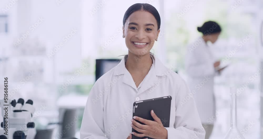 Poster Confident African biologist working on research using modern technology at medical science laboratory. Portrait of a young scientist using a digital tablet on blur background in a lab with coworkers