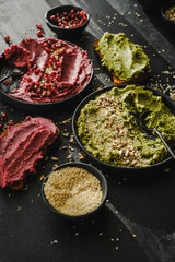 Beetroot hummus and spinach hummus. Vegan recipes, plant-based dishes. Homemade healthy organic food. Vegetarian cuisine. Top view 