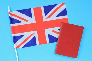 Passport and flag of Great Britain on blue background. Immigration, refugee, change of citizenship, refuge, residence, brexit European Union concept. Travel, recieving visa and tourism idea