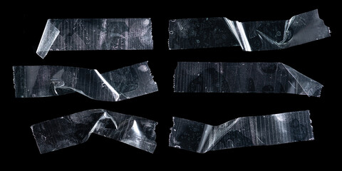 Set of transparent adhesive plastic tape pieces isolated on black background,Crumpled glue plastic...