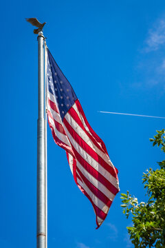 American flag with plane flying in the background in Prescott, Arizona