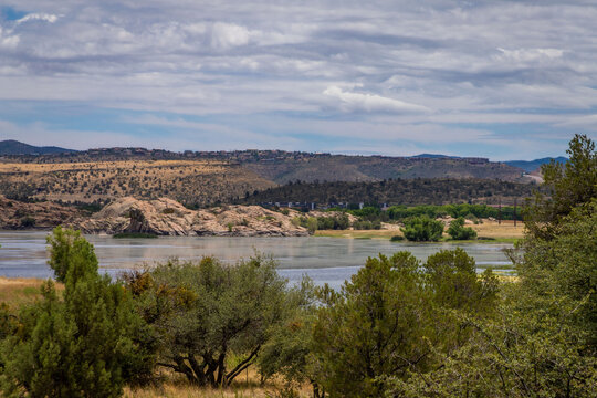 Prescott Arizona lake in the distance with desert trees in the foreground