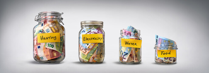 Four glass jars for savings, cash money (euro banknotes) on grey background. For utility bills: heating, electricity, water. Savings for life and food