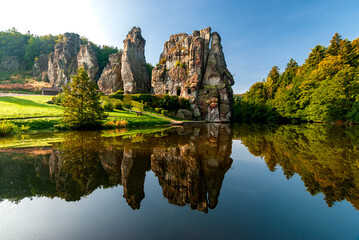 Famous rock formation Externsteine in the Teutoburg Forest near Paderborn in the state of North Rhine-Westphalia in Germany - obrazy, fototapety, plakaty