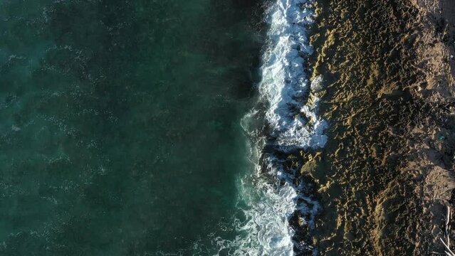 Tropical stony beach with caribbean sea waves. Travel destination. Aerial top view