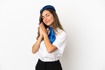 Airplane stewardess over isolated white background making sleep gesture in dorable expression