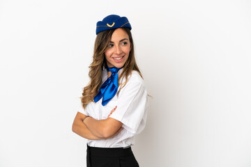 Airplane stewardess over isolated white background with arms crossed and happy