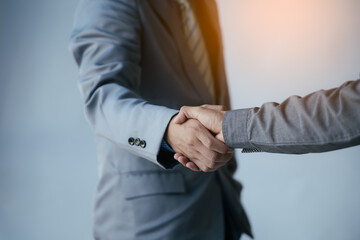 Fototapeta premium Close up of a man wear suite and have a handshaking with partner and colleague.