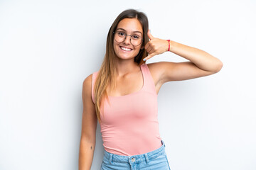 Young caucasian woman isolated on white background making phone gesture. Call me back sign