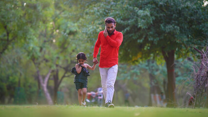 alone sad kid concept man is busy on call with cute baby girl in park images