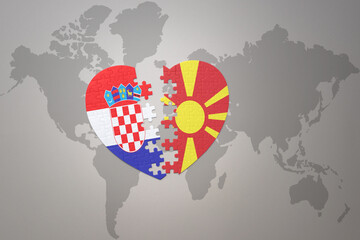 puzzle heart with the national flag of croatia and macedonia on a world map background.Concept.