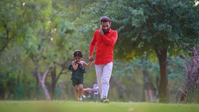 alone sad kid concept man is busy on call with cute baby girl in park images