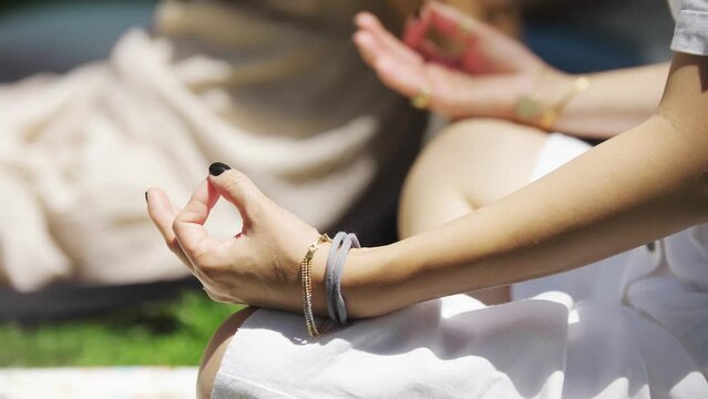 Women meditating on the grass during religious festival