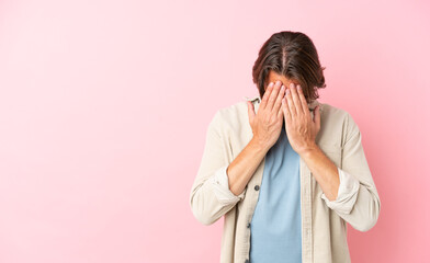 Senior dutch man isolated on pink background with tired and sick expression