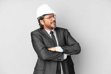 Young architect man with helmet over isolated background happy and smiling