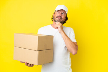 Delivery senior dutch man isolated on yellow background having doubts and thinking