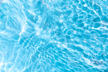 Blue water waves in sunlight. Abstract surface for background.