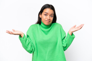 Young Colombian woman isolated on white background having doubts while raising hands