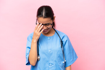 Young nurse Colombian woman isolated on pink background laughing