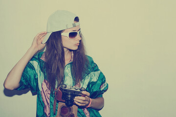 Cool teenager. Fashionable girl in colorful trendy jacket and vintage retro sunglasses in 80s - 90s...