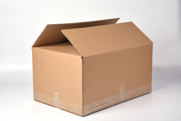 brown cardboard box sealed with adhesive tape on a white background