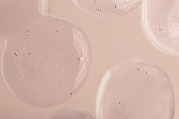 Top view of liquid cosmetics gel with bubbly structure on pastel beige background.Good as cosmetic mockup.