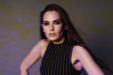Fashion portrait of a brunette with long hair and 90s style makeup through a crystal filter,...