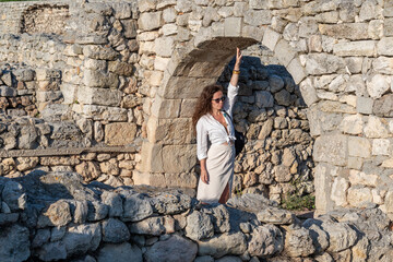 A girl walks through the ruins of an ancient ancient city