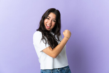 Young caucasian woman isolated on purple background celebrating a victory