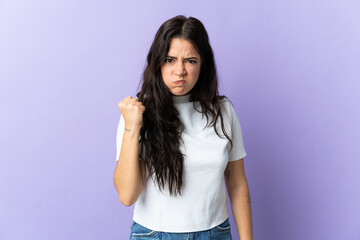 Young caucasian woman isolated on purple background with unhappy expression