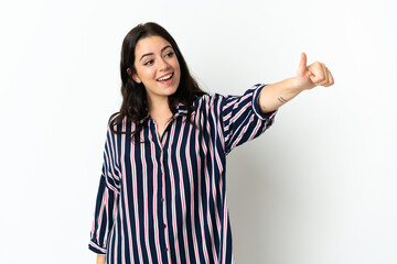 Young caucasian woman over isolated background giving a thumbs up gesture