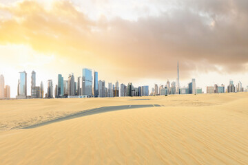 Stunning view of a road covered by sand dunes with the Dubai Skyline in the distance. Dubai, United...