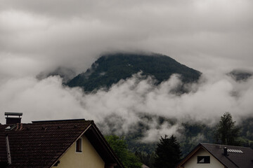 Fototapeta na wymiar mountain village in the fog in austria during summer holiday