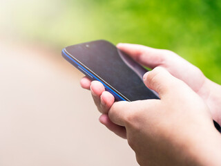 A smartphone in the hands of a young man. Using gadgets