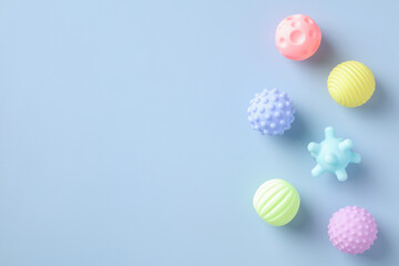 Colorful baby bathing toys on blue table. Flat lay, top view.