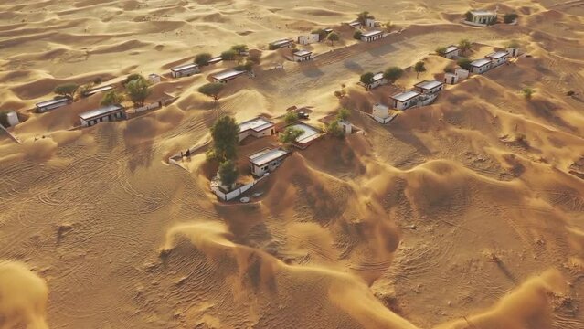 Desert buried village with sand at UAE. Land of lost. On a strip of desert behind the town of Al Madam lies a tiny ghost village lost in sand. (aerial photography)