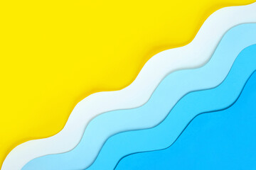 Seashore diagonal background made of color paper. Yellow beach sand with copy space and paper cut...