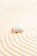 Fototapeta na wymiar Japanese Zen stone garden. relaxation, meditation, simplicity and balance concept. pebbles and wavy sand tranquil calm scene