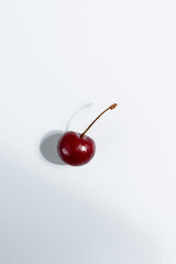  cherries on a white background, hard light © Алиса Сандулович