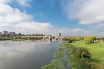 Fototapeta na wymiar Amazing morning view at the Guadiana river and Palmas bridge, Guadiana Park river on banks, Badajoz downtown city, Spain