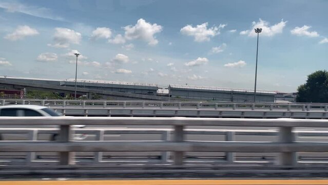 View through the side window of moving car on the road.