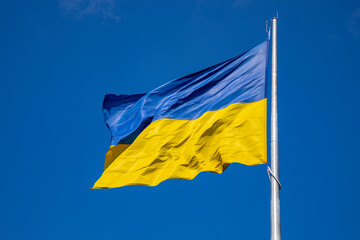 Flag of Ukraine on a background of blue sky. The largest flag in Ukraine.