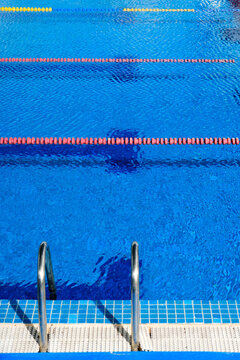 Competitive Swimming Pool Lanes With Ladder In The Foreground Empty Pool