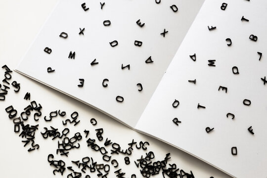 letters of the English alphabet are scattered on a blank white sheet, grammar and spelling, learning foreign languages, TOEFL test