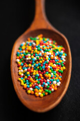 colorful sprinkles on the wooden spoon