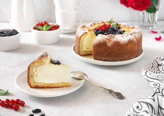 Homemade german cheesecake kasekuchen with berries on beautiful plate on table. Natural light, selective focus.