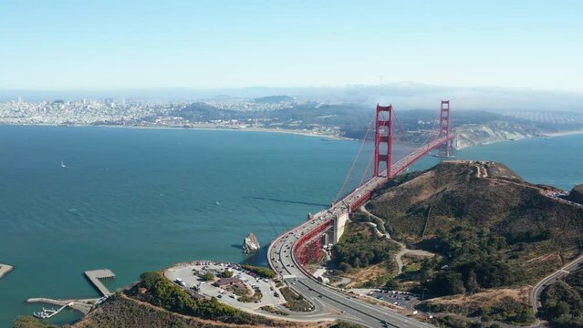 Aerial moving shot of Golden Gate Bridge and San Francisco skyline in Bay Area